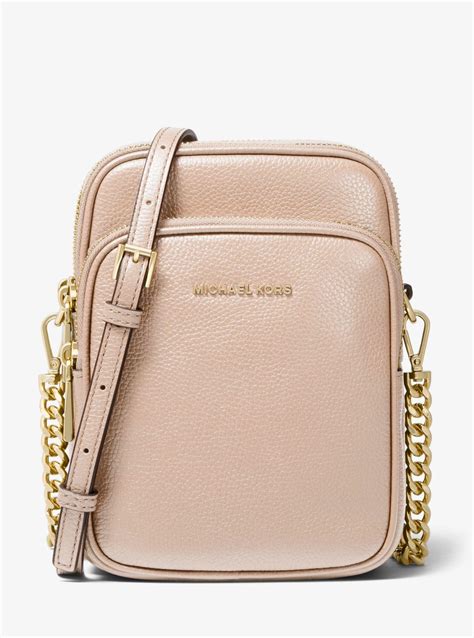 michael michael kors jet set large pebbled leather crossbody bag|Michael Kors bag with airplanes.